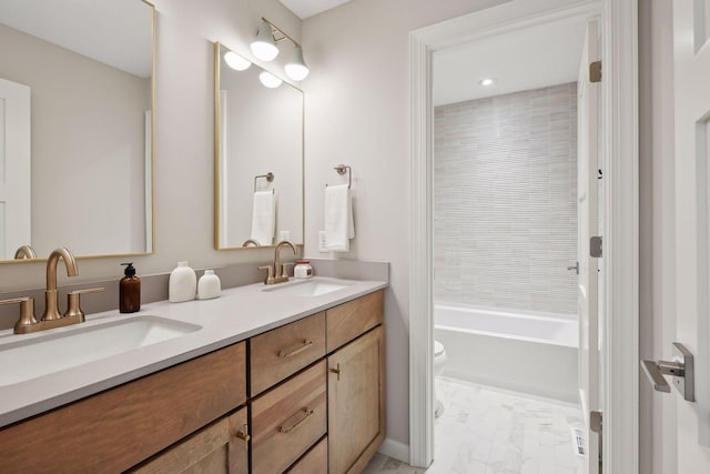 full bathroom with toilet, vanity, and tiled shower / bath