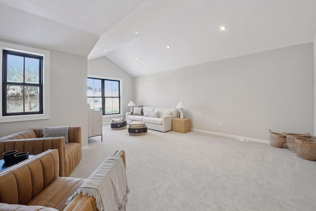 carpeted living room with a textured ceiling and lofted ceiling