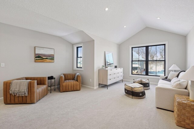 living room with a textured ceiling, light colored carpet, and lofted ceiling