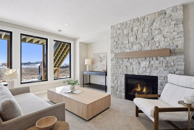 living room with a textured ceiling, light carpet, and a stone fireplace