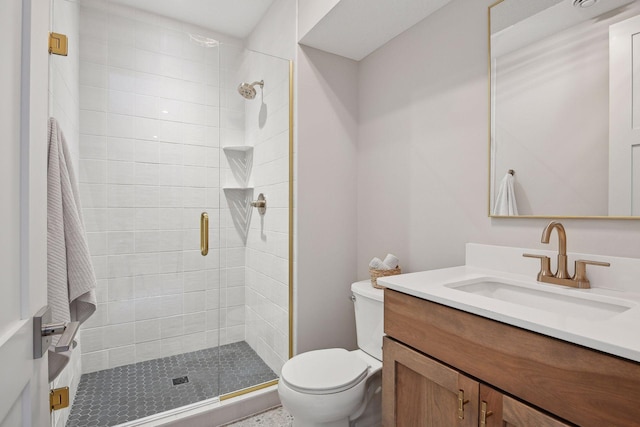 bathroom with an enclosed shower, vanity, and toilet