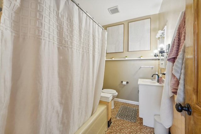 full bathroom with tile patterned flooring, vanity, toilet, and shower / bath combo with shower curtain