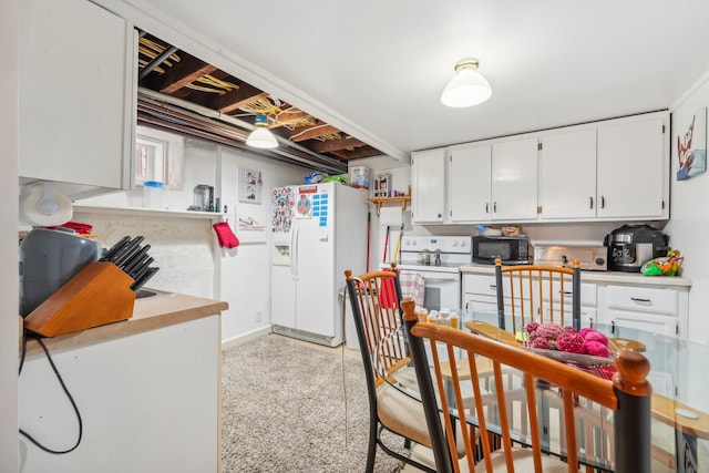 kitchen featuring white appliances and white cabinets