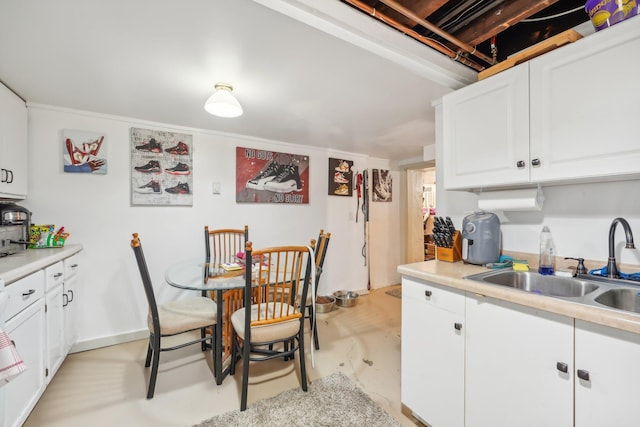 kitchen featuring sink and white cabinetry