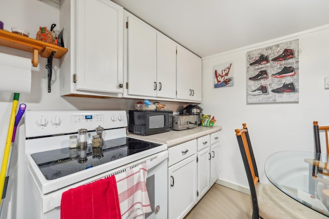 kitchen featuring white cabinetry and white electric range oven