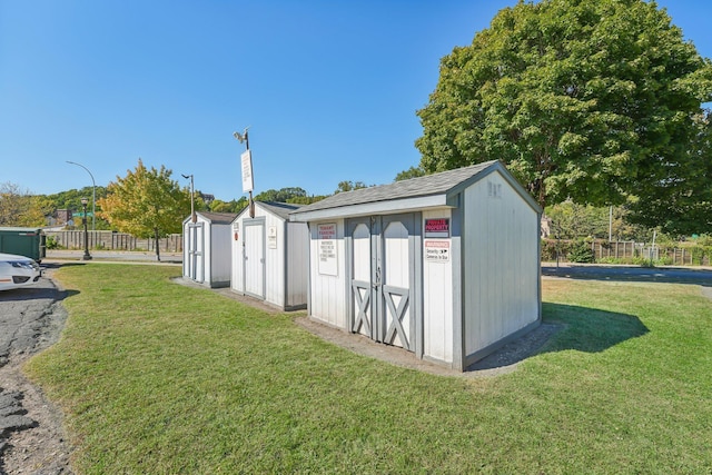 view of outbuilding with a yard