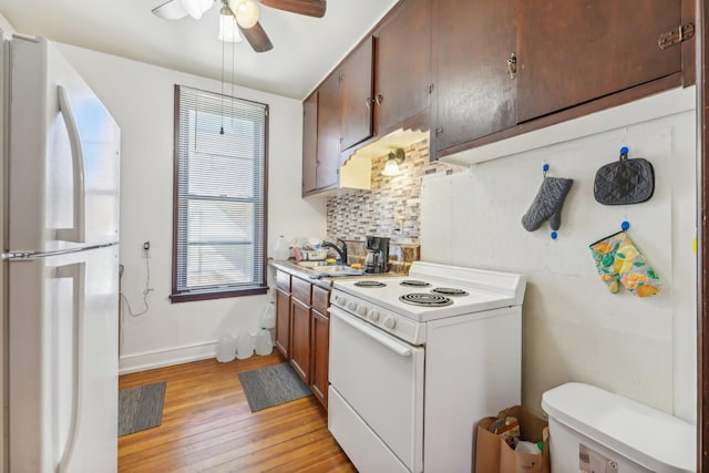 kitchen with decorative backsplash, light hardwood / wood-style floors, white appliances, ceiling fan, and sink