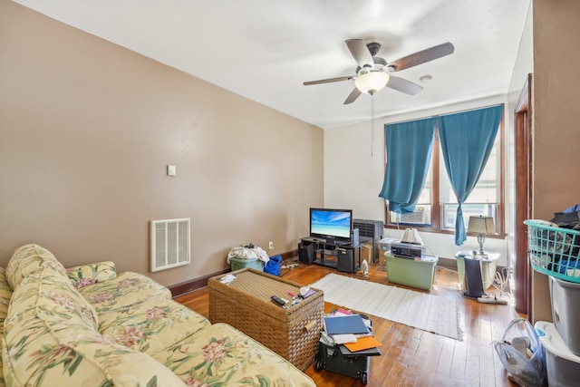 living room featuring hardwood / wood-style floors and ceiling fan