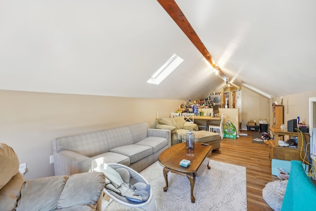 living room featuring wood-type flooring and vaulted ceiling with skylight