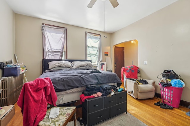 bedroom with ceiling fan and hardwood / wood-style flooring