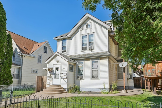 front of property featuring cooling unit and a front lawn