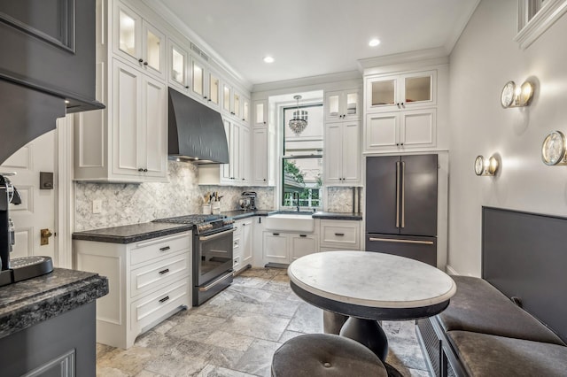 kitchen with stainless steel appliances, white cabinetry, ornamental molding, and sink