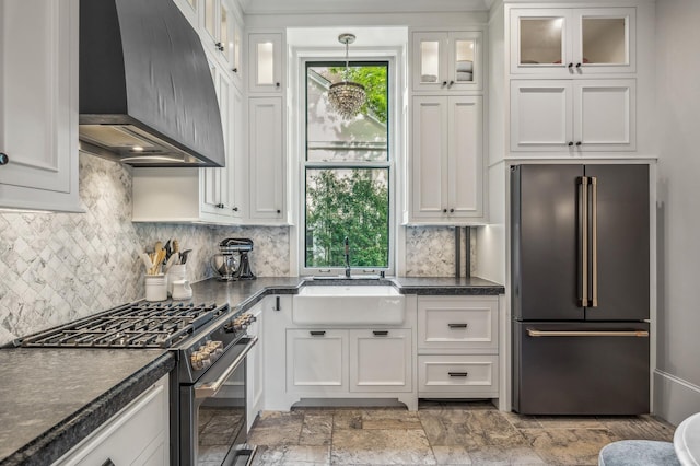 kitchen with white cabinetry, extractor fan, high end appliances, and sink