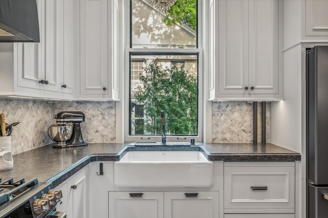 kitchen with a healthy amount of sunlight, white cabinetry, and stainless steel appliances