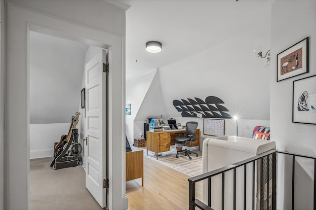 home office featuring light hardwood / wood-style flooring and vaulted ceiling