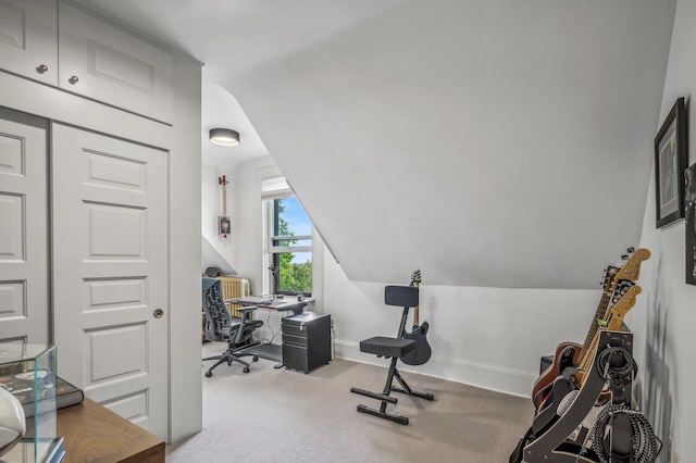 office with light carpet and vaulted ceiling