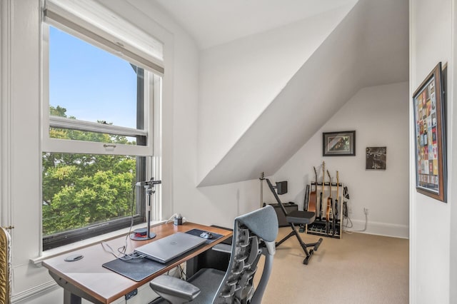 carpeted home office with lofted ceiling