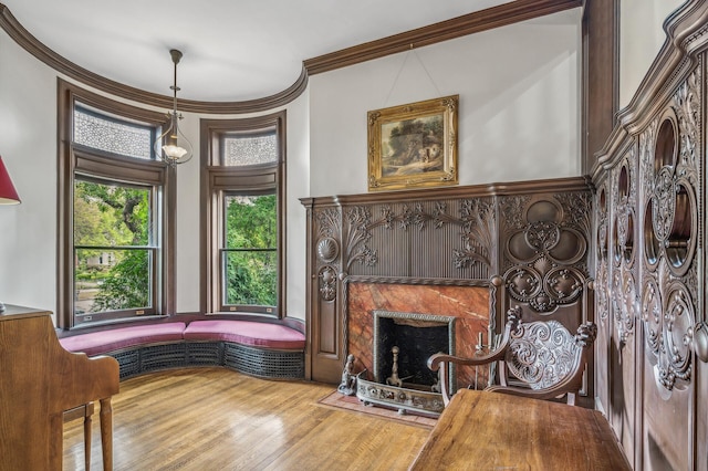 sitting room with hardwood / wood-style floors and ornamental molding