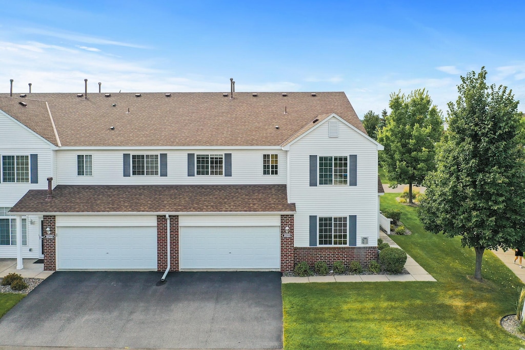 view of front of property with a front lawn and a garage