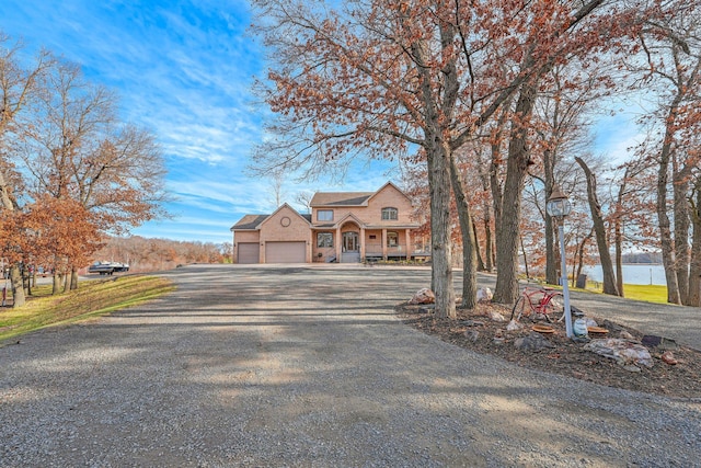 view of front of property with a water view and a garage