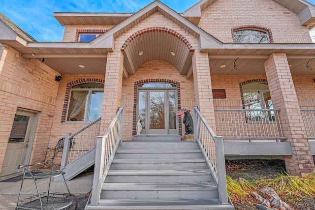 property entrance with a porch and french doors