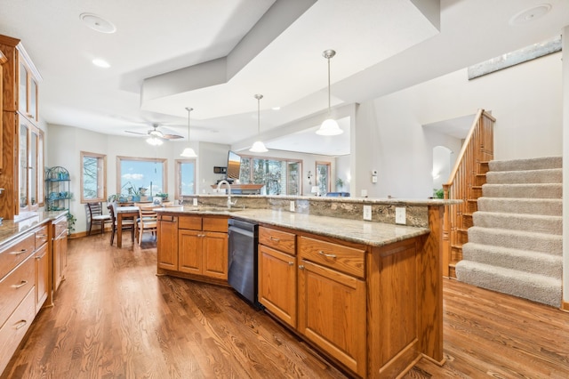 kitchen featuring hanging light fixtures, ceiling fan, dishwasher, and dark hardwood / wood-style flooring