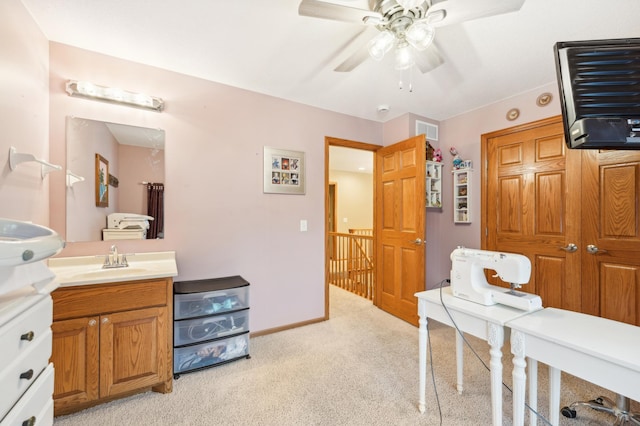 interior space with ceiling fan, sink, and light colored carpet