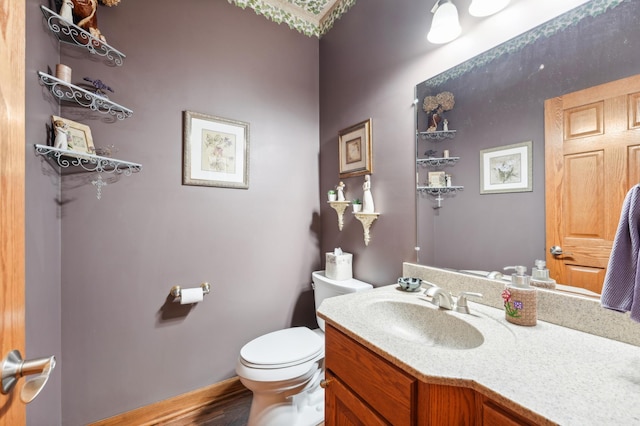 bathroom with toilet and vanity