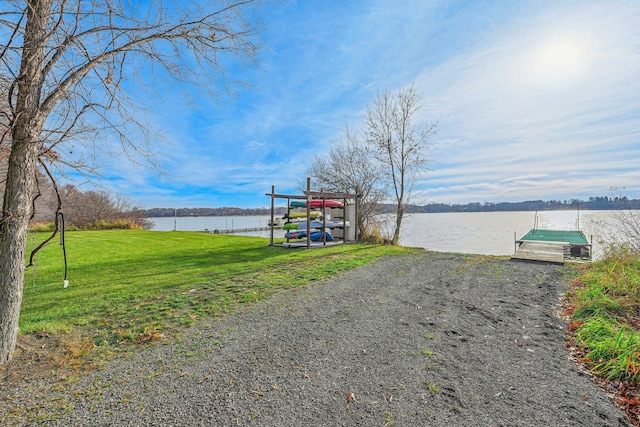 exterior space with a water view and a dock