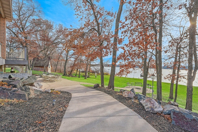 view of home's community featuring a yard and a patio