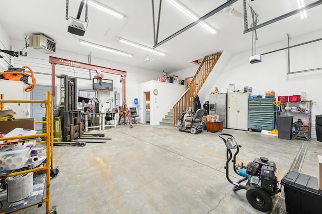 garage with stainless steel fridge with ice dispenser and a garage door opener