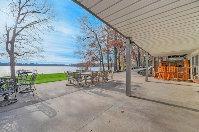 view of patio featuring a water view and a bar