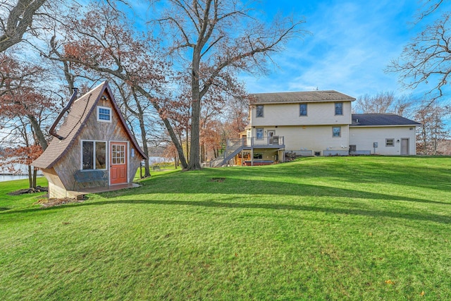 back of house featuring a wooden deck and a yard