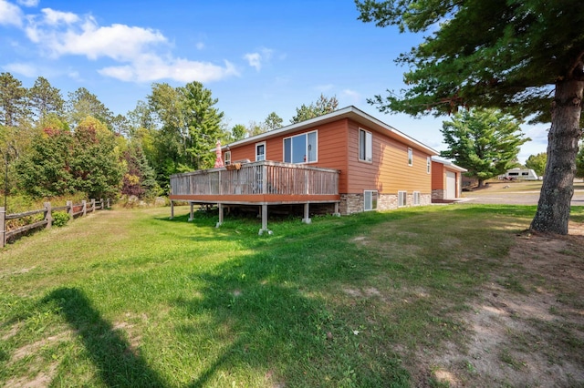 back of house with a yard and a wooden deck