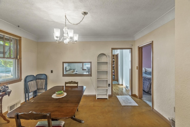 dining room featuring a notable chandelier and a textured ceiling