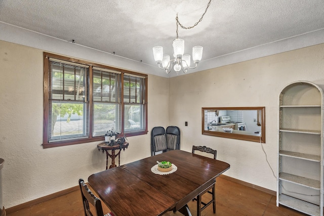 dining room with a textured ceiling and a chandelier