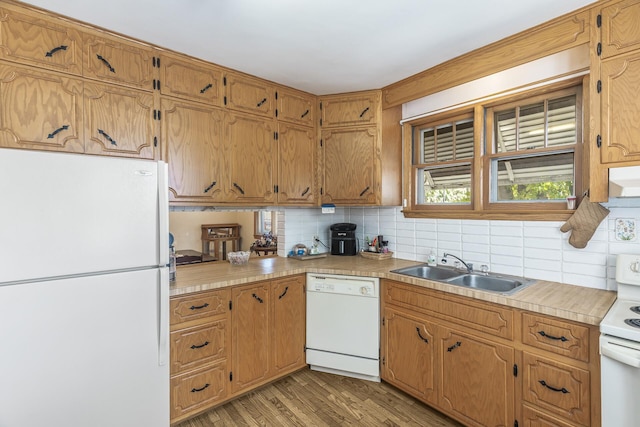 kitchen featuring white appliances, light hardwood / wood-style flooring, decorative backsplash, and sink