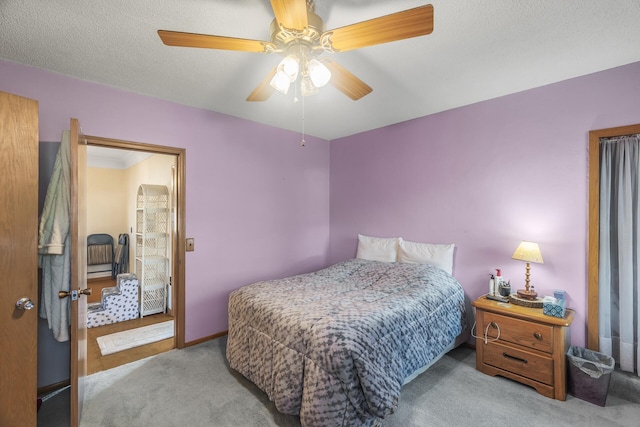 carpeted bedroom featuring a textured ceiling and ceiling fan