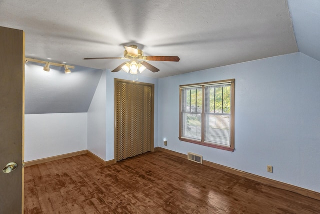 bonus room featuring hardwood / wood-style floors, ceiling fan, a textured ceiling, and vaulted ceiling