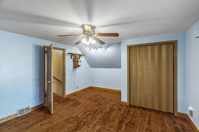 additional living space featuring ceiling fan, a textured ceiling, and dark hardwood / wood-style flooring