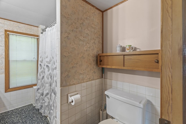 bathroom with toilet, walk in shower, and tile walls