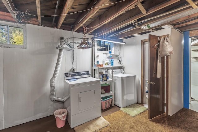 basement featuring washing machine and clothes dryer and carpet floors