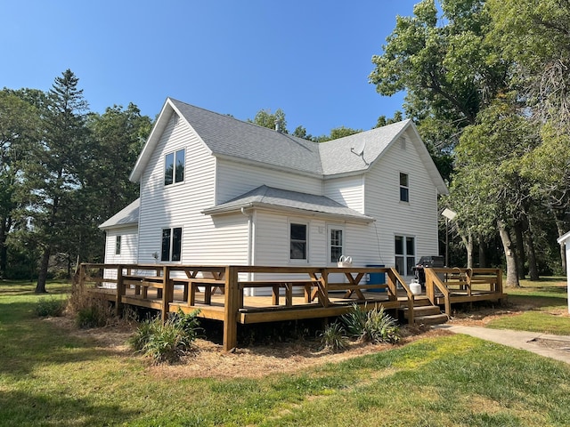 rear view of property with a yard and a deck