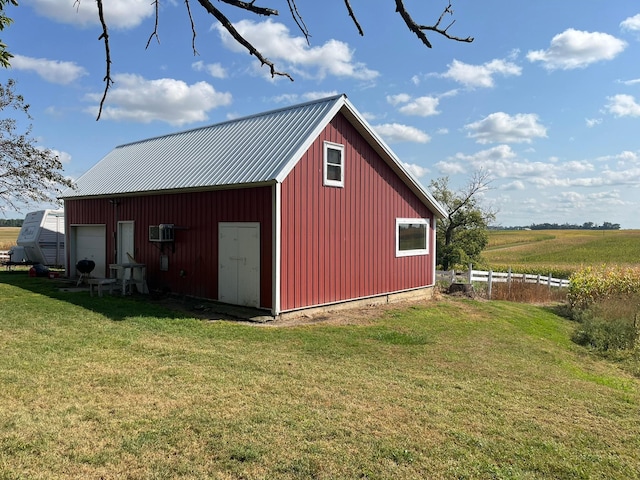 view of outdoor structure featuring a rural view and a yard