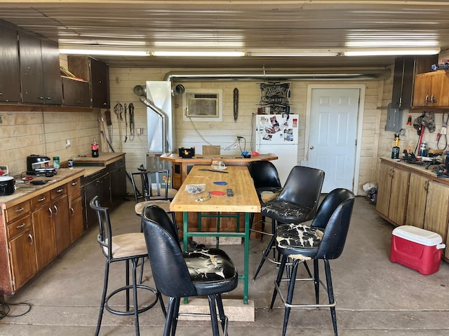 dining room featuring a workshop area and a wall mounted AC