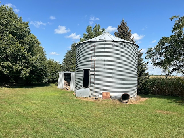 view of outbuilding with a yard