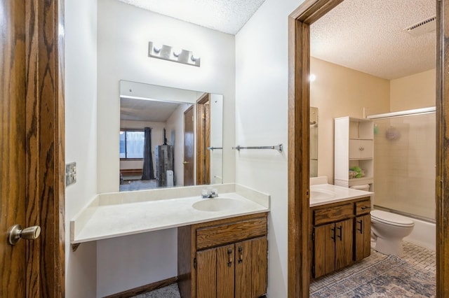 full bathroom with toilet, tile patterned flooring, a textured ceiling, shower / bath combination with glass door, and vanity