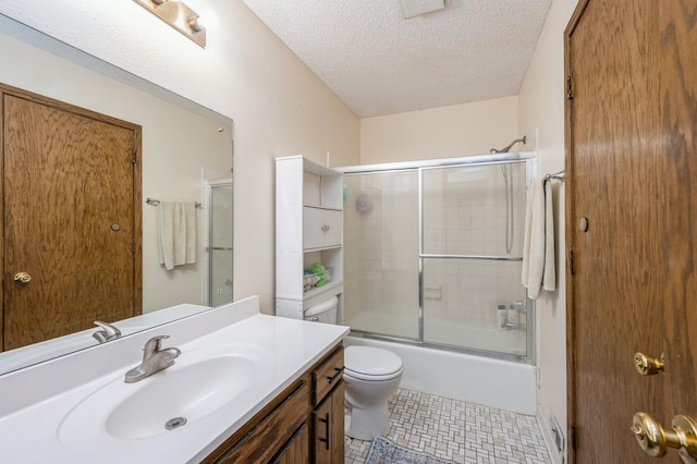 full bathroom with toilet, vanity, a textured ceiling, and enclosed tub / shower combo