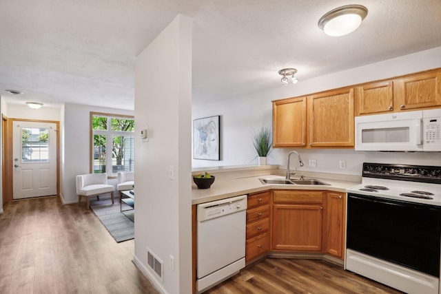 kitchen featuring a textured ceiling, white appliances, sink, and dark hardwood / wood-style flooring