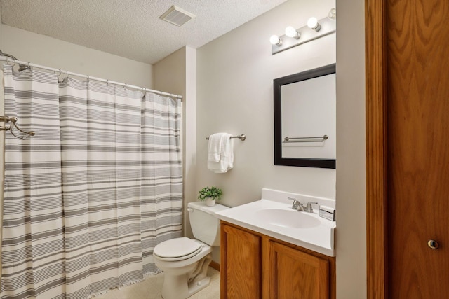 bathroom featuring vanity, toilet, a textured ceiling, and curtained shower